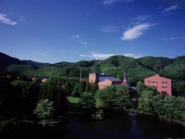 An aerial view of Miyagikyo Distillery surrounded by lush green forest in Sendai, Miyagi Prefecture.