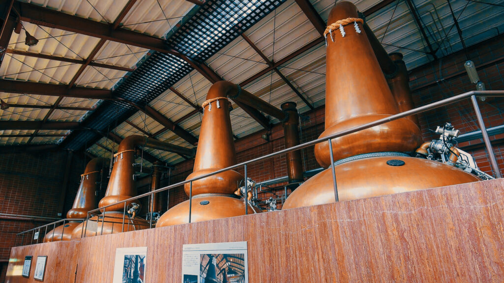 Shining copper stills at Miyagikyo Distillery used in the whisky distillation process.