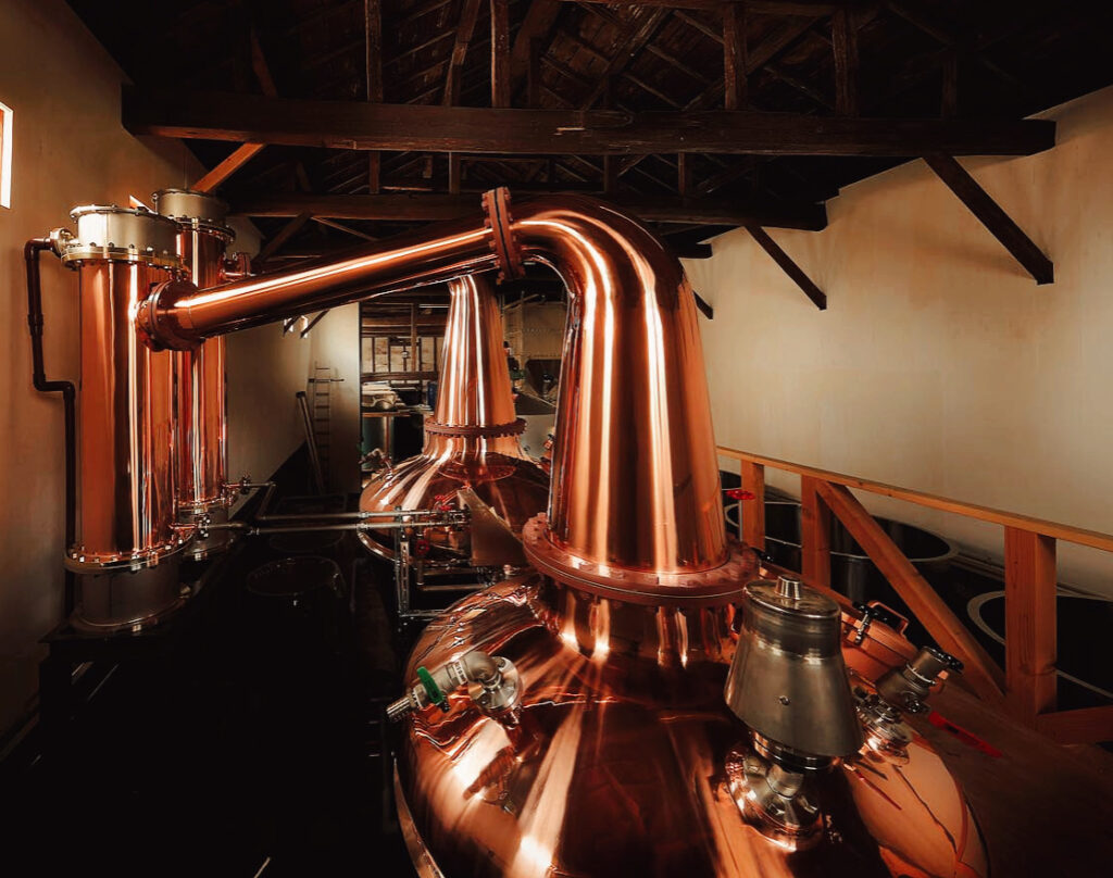 Handcrafted copper stills at Aska Distillery showcasing traditional Japanese whisky craftsmanship.