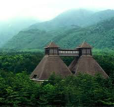 A picturesque view of Hakushu Distillery surrounded by lush green forests in the Japanese Alps.